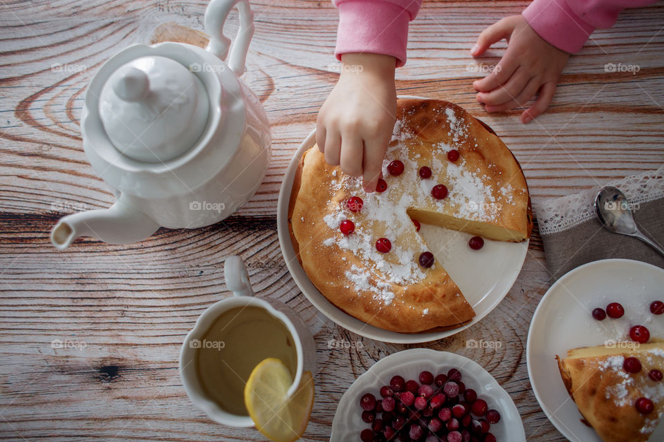 Children breakfast with cheesecake. Hands, detail