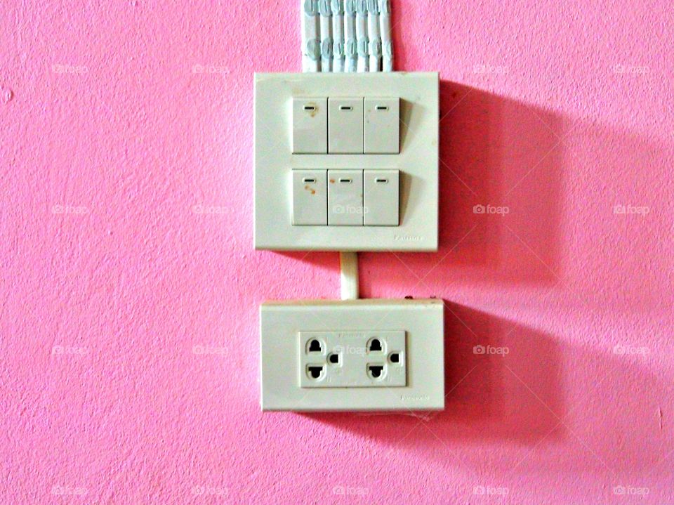 Light switches on pink wall