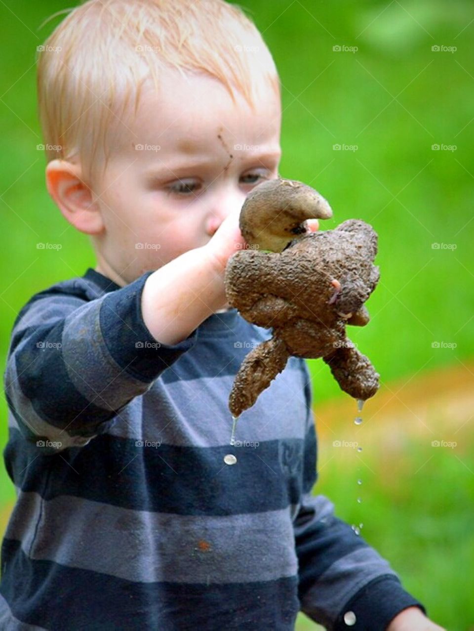 Toddler with a very wet and dirty toy