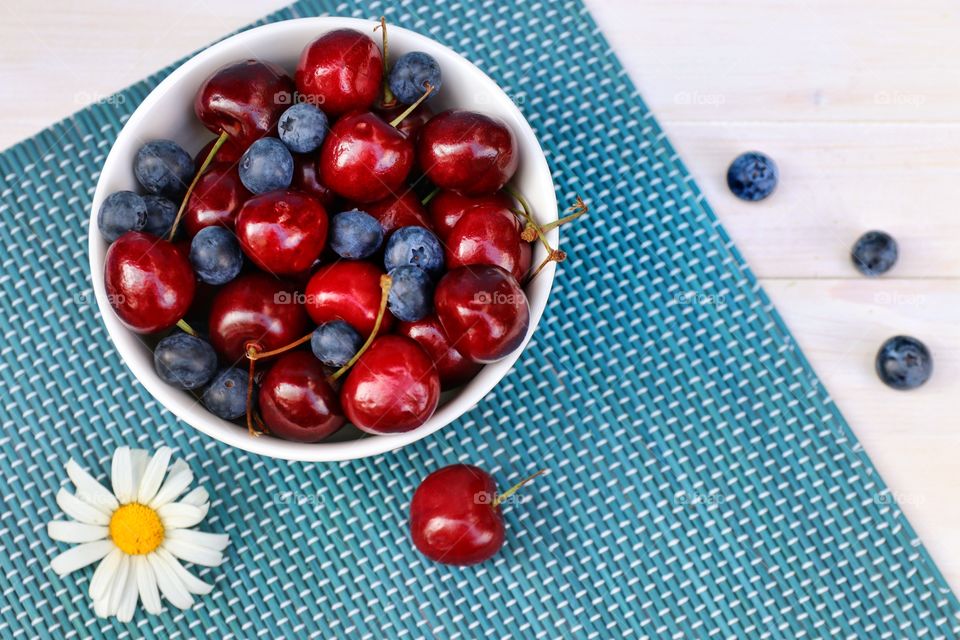 still life with cherries and blueberries in a plate