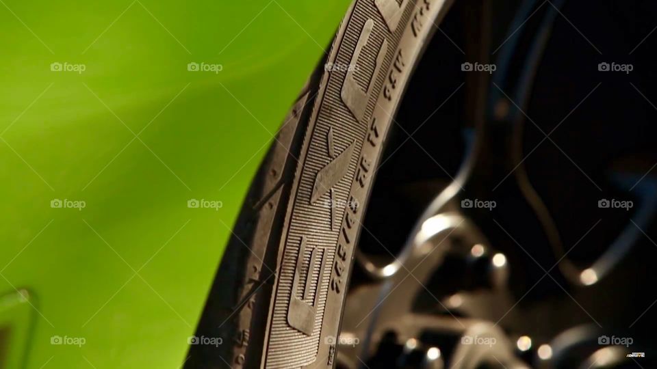 Automotive Abstract. Up close rim and tire shot with body work visible