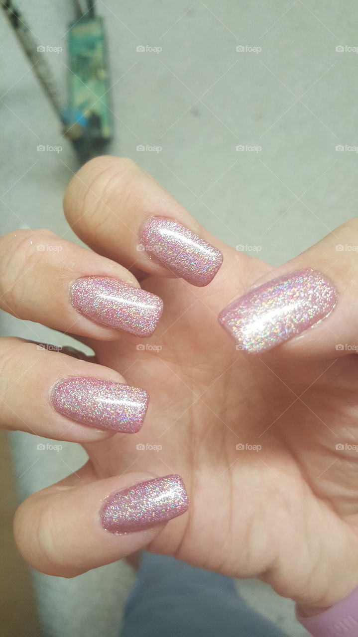 sculpted nail with bright pink gel polish and holographic powder