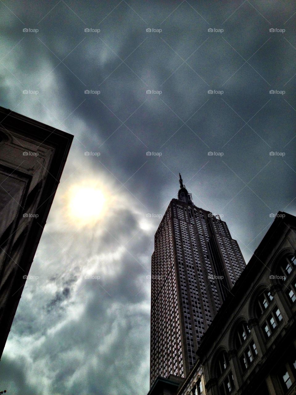 Empire State Building, New York City. Empire State Building, New York City. Sun, clouds, sky. Gotham city.