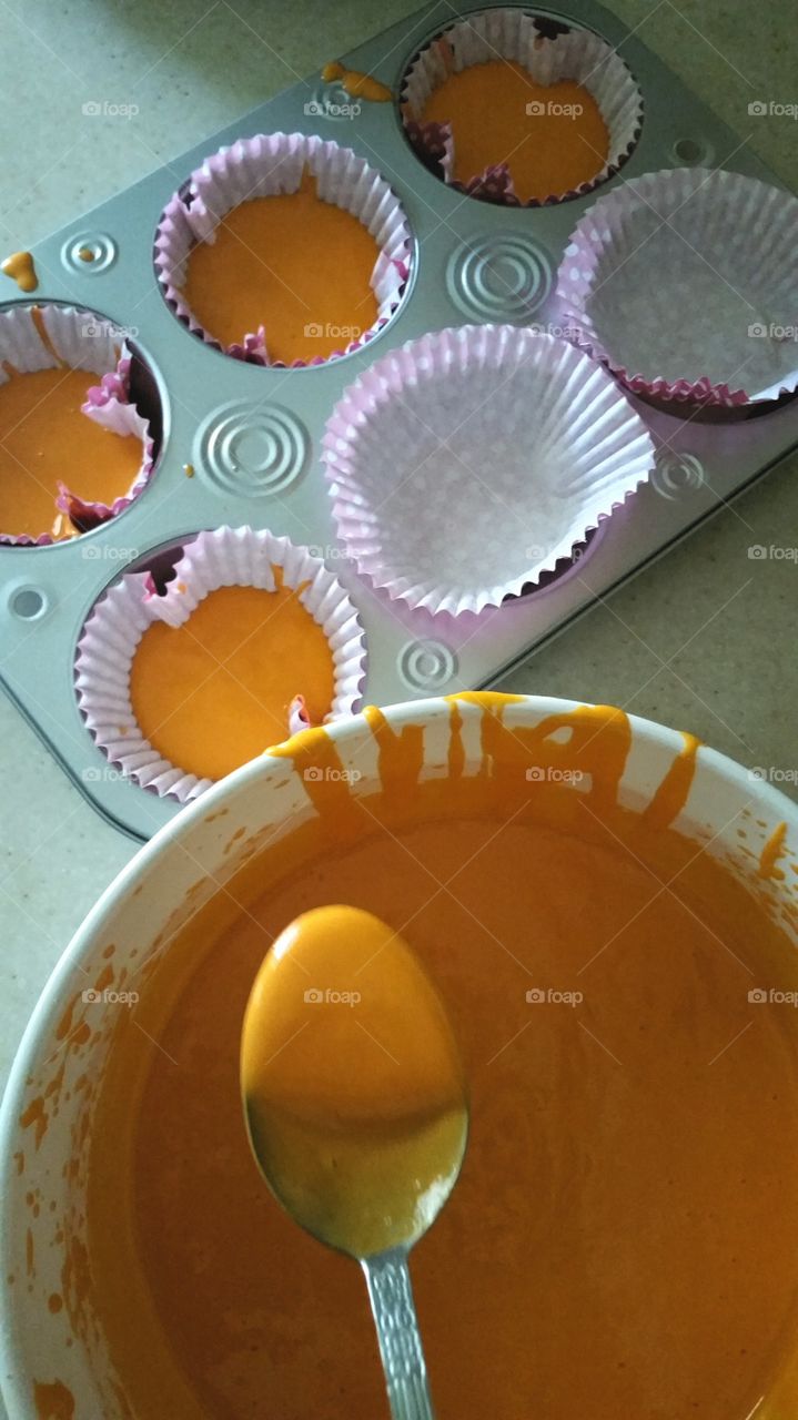 Pouring cupcake batter into pan