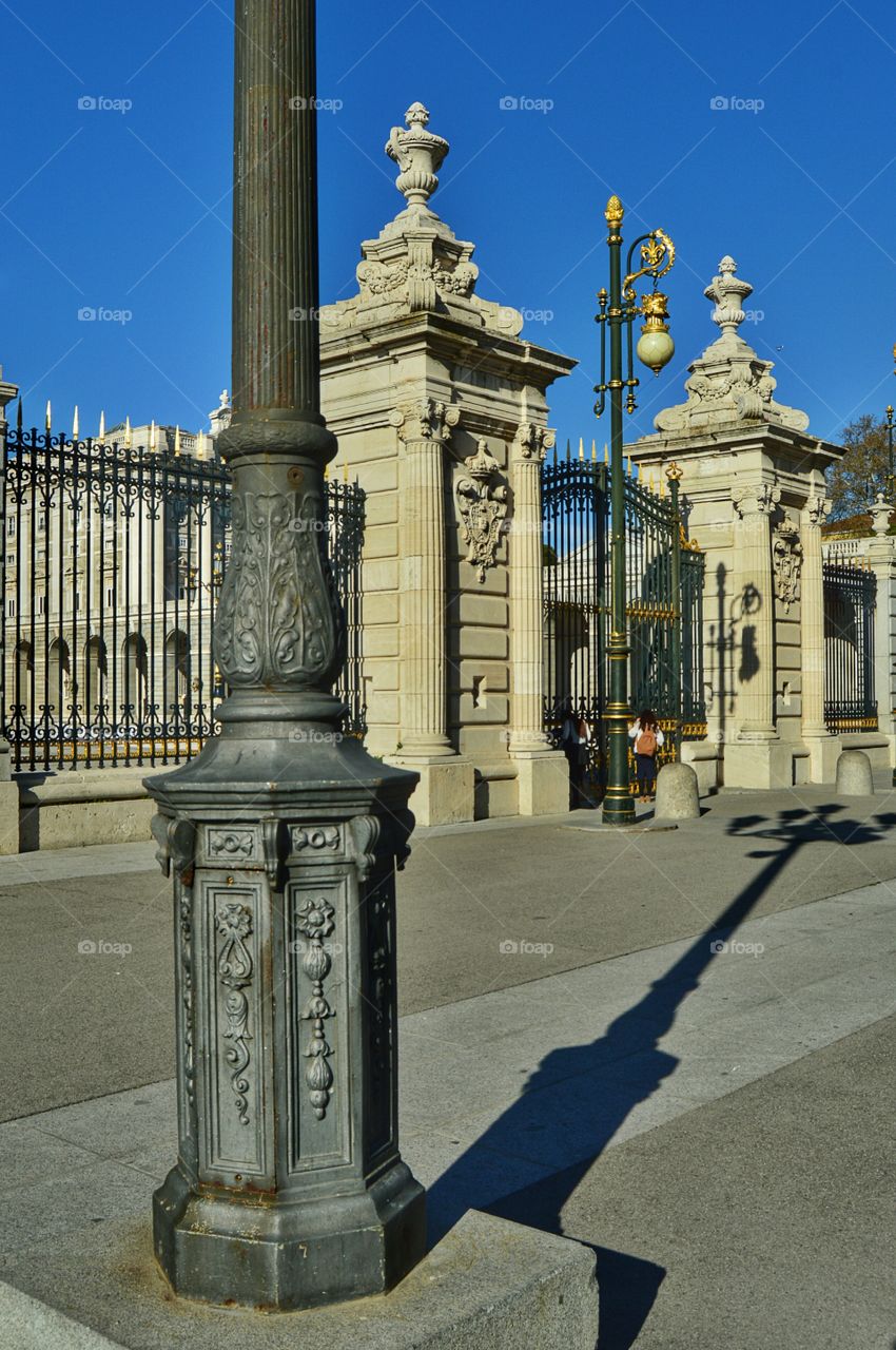 Lamp post and shadow. Lamp posts and shadow at Plaza de la Armería, between the Royal Palace and Almudena cathedral, Madrid