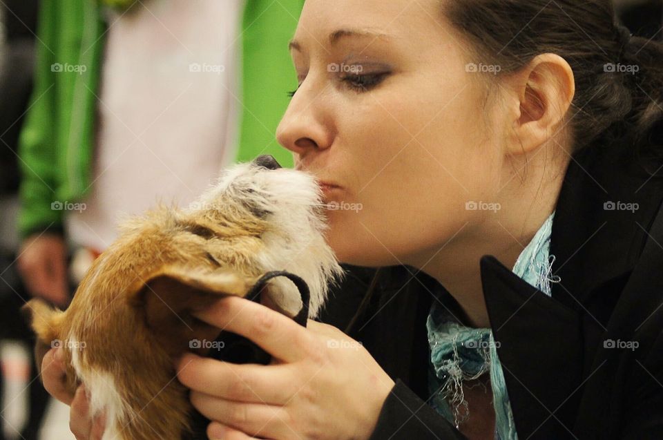 Woman giving a dog a kiss