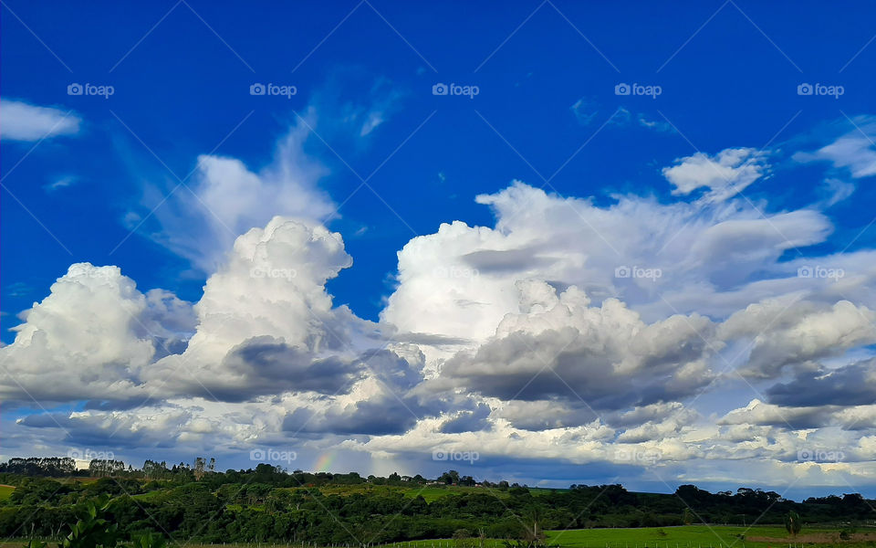 Moment to contemplate the clouds. You can even see a rainbow deep down.