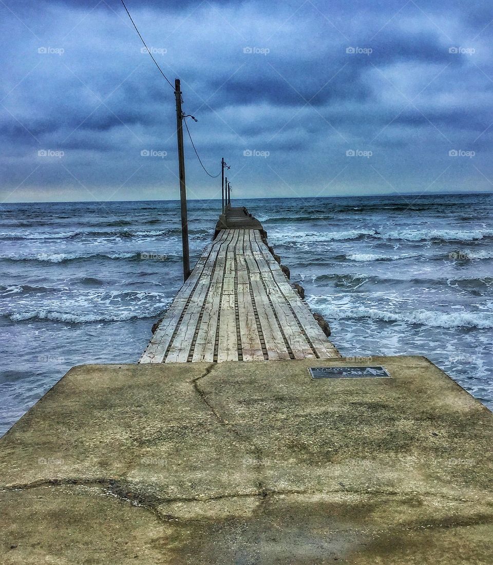 Pier in stormy waters