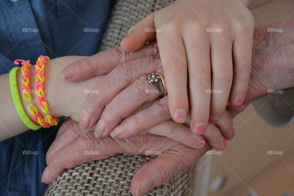 Girl holding her grandmothers hand