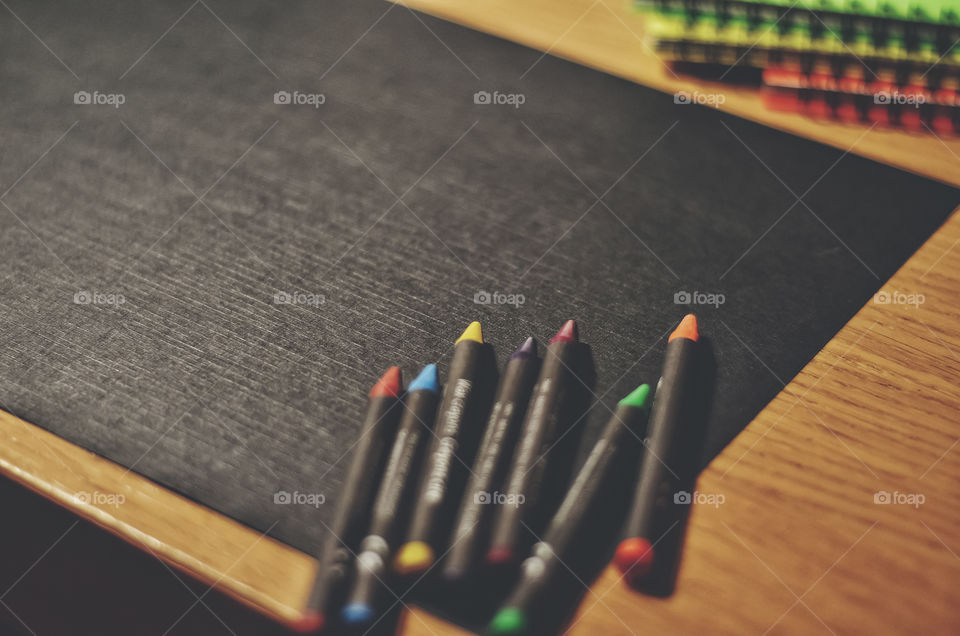 Black background and colorful pencils.