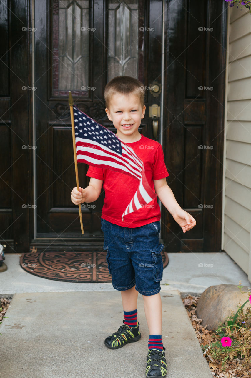 Toddler holding American flag