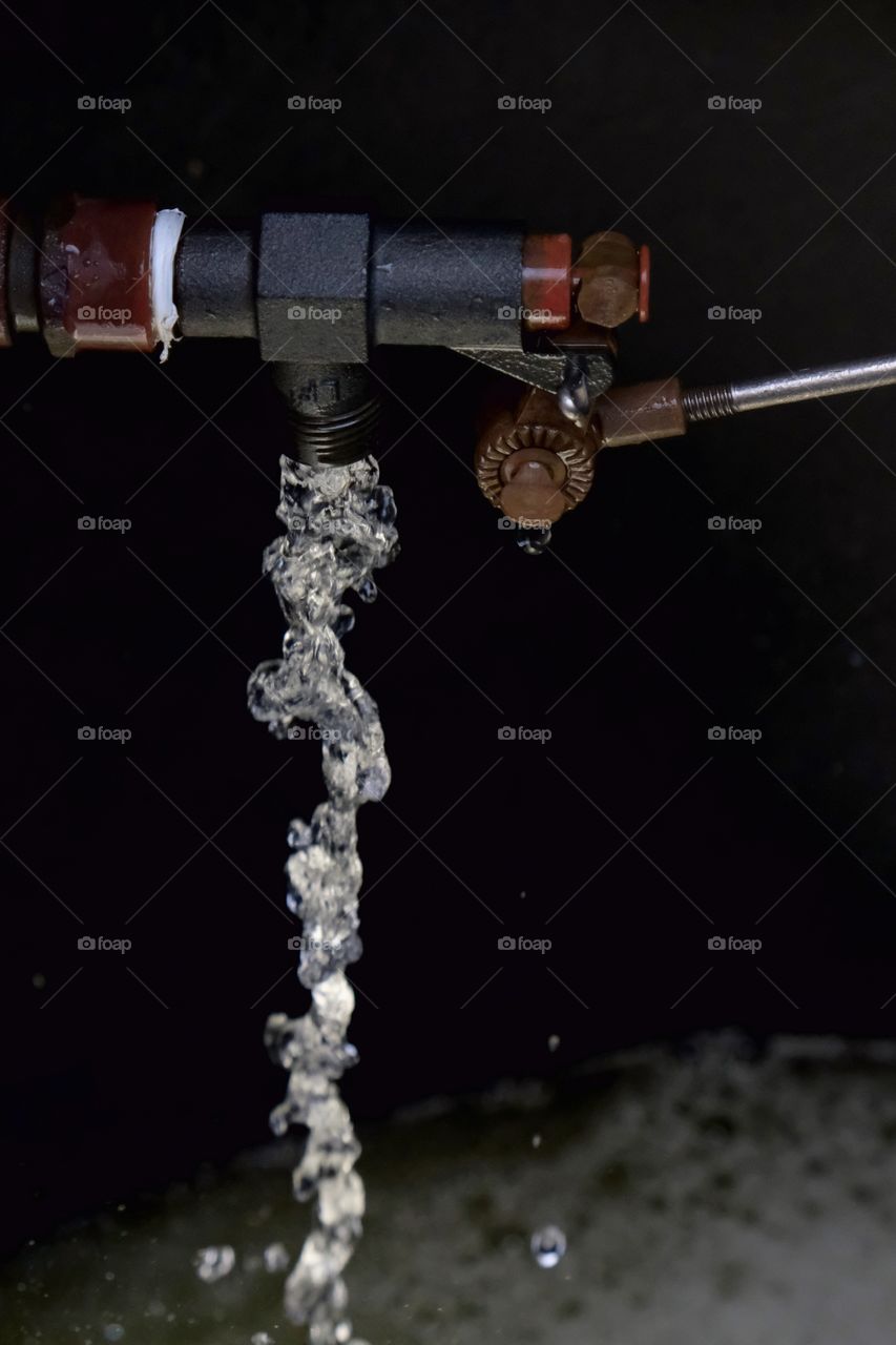 A bronze float used to control the water level in an agricultural tank. 