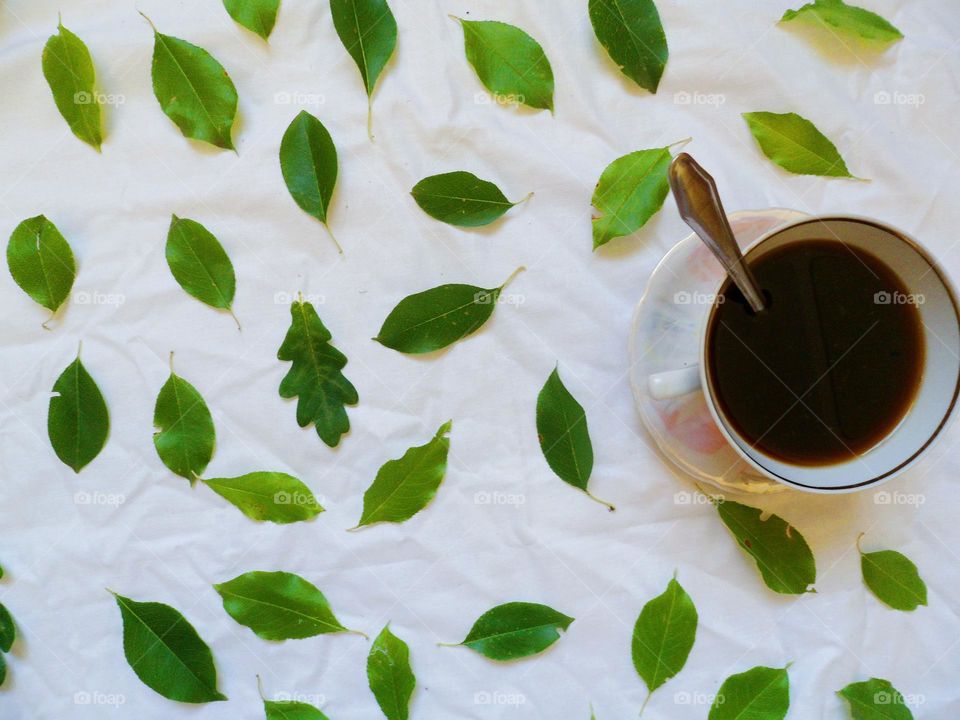 a cup of coffee and leaves