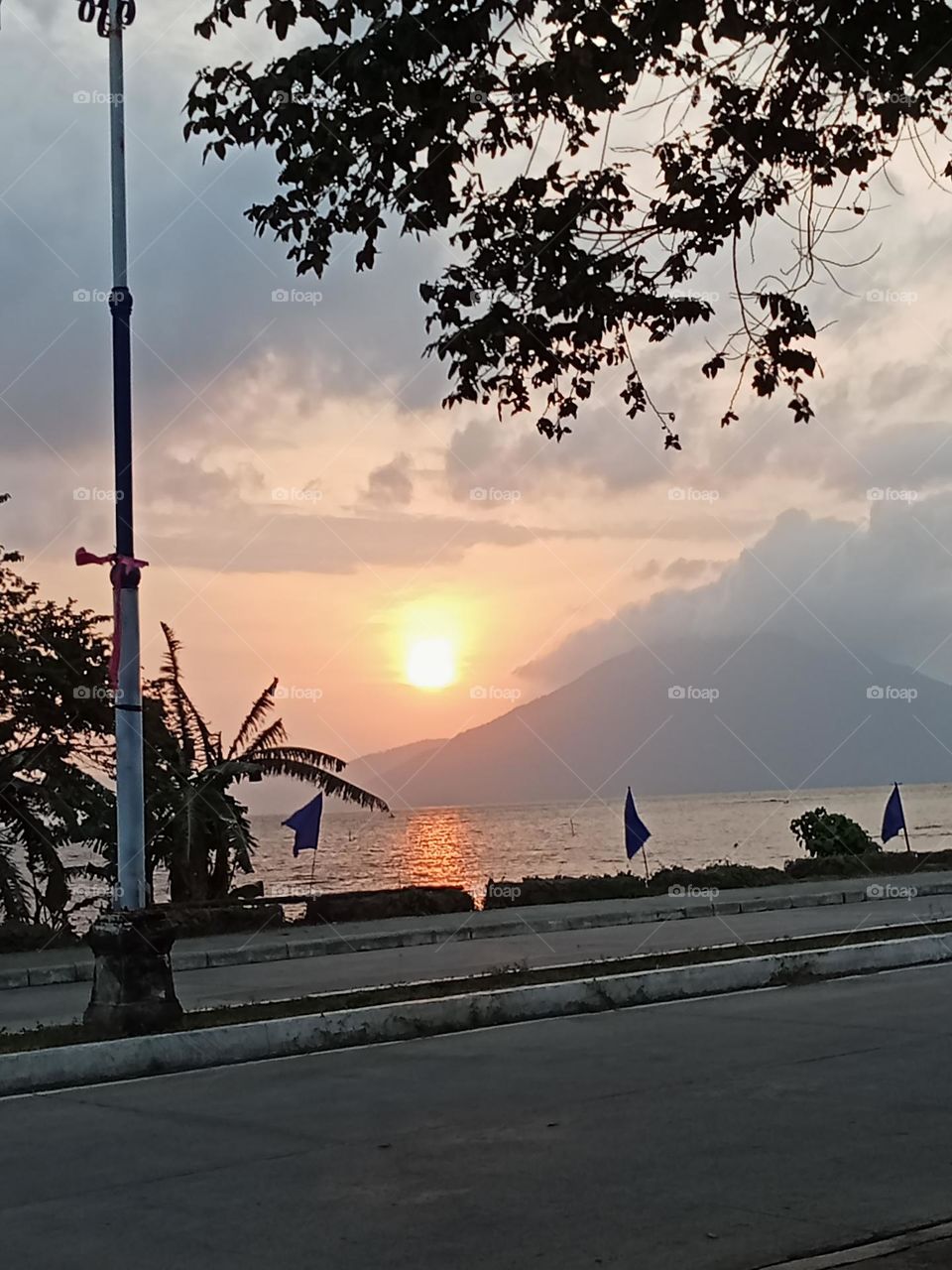 a spectacular sunrise over the summit of the mountain and below the peaceful lake