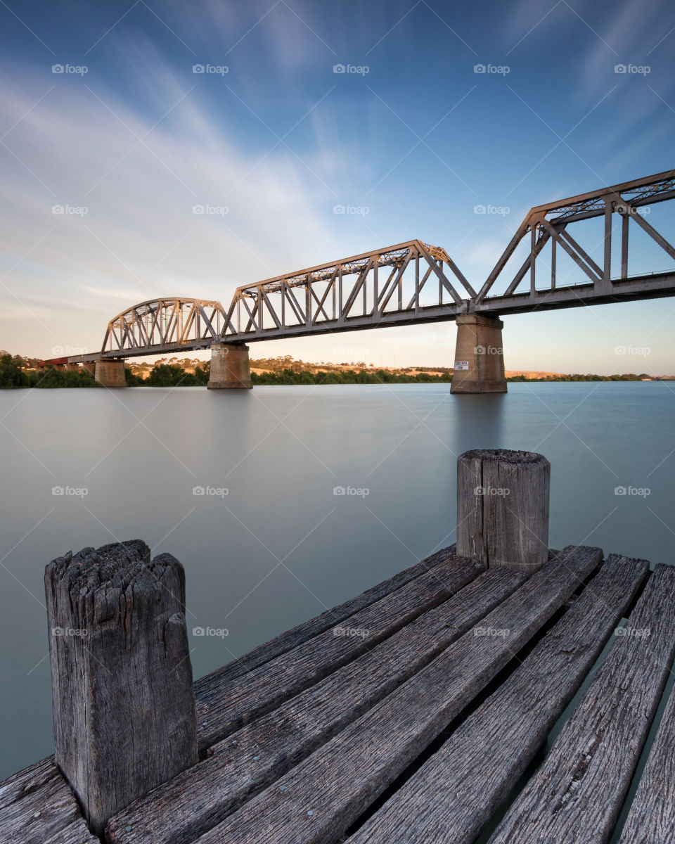 Beautiful Bridge over calm river during sunset