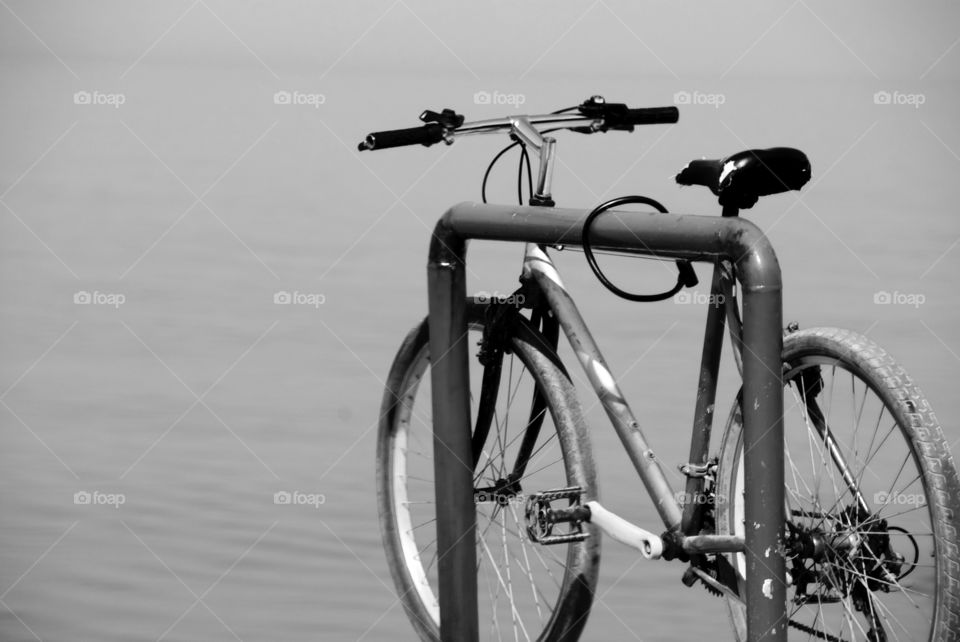 Bicycle parked on sea shore above 