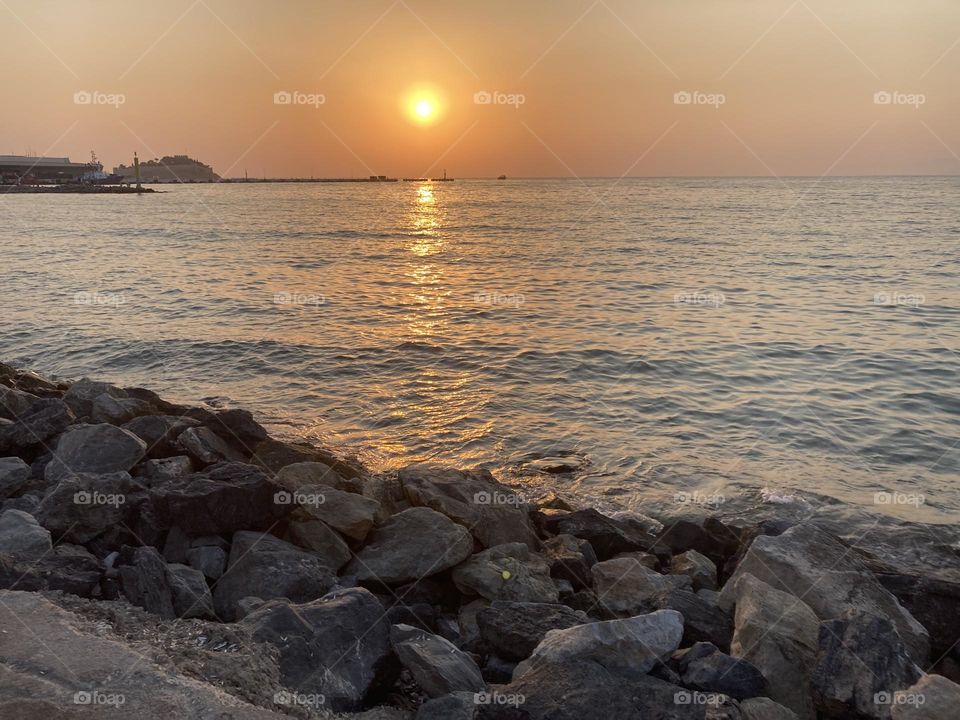 Sunset in Turkey. Blue sky and tall palm trees. Sunsets and sunny days. Summertime in Kusadasi. Vacation travel in Turkey . Summer view. Sunny day during vacation. Hidden gems and secret places.