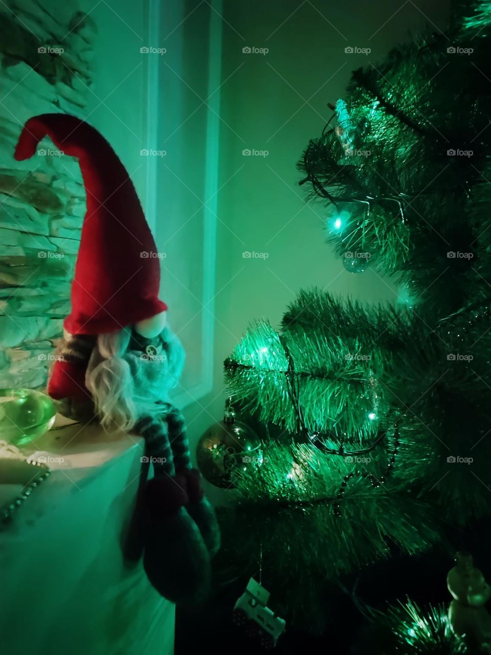 gnome sitting on the fireplace near the tree