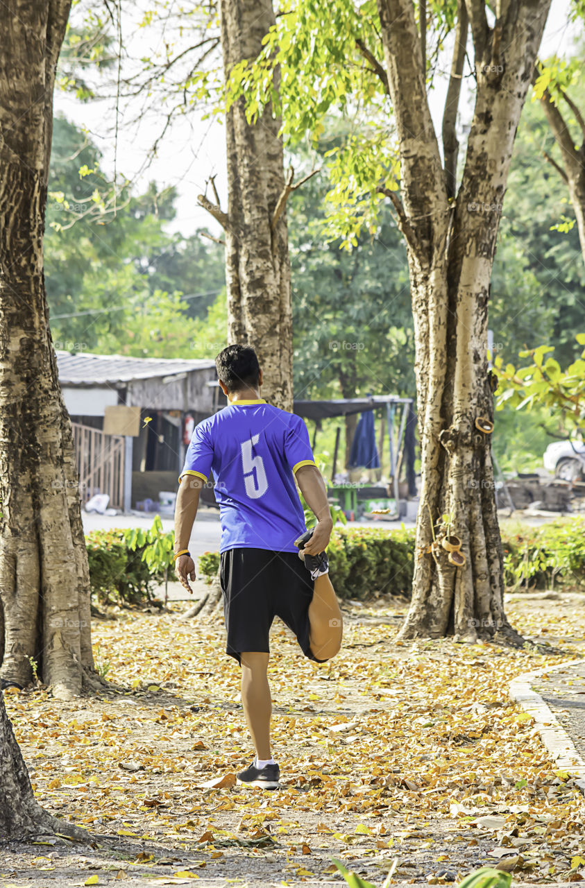 Asean man is warmed up before exercise in the park.