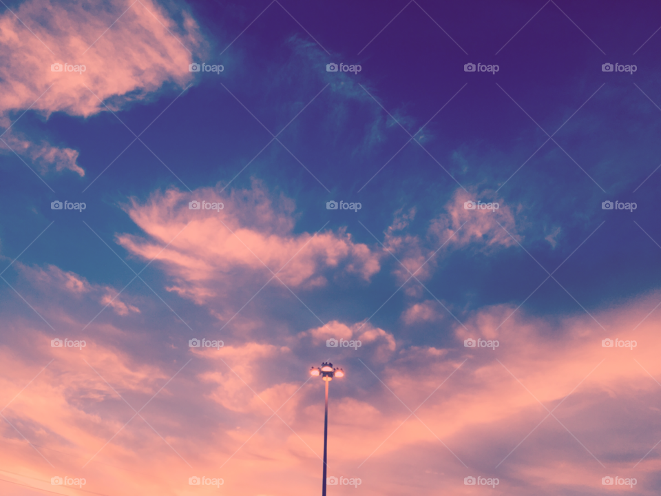 Electric street lamp at sunset
