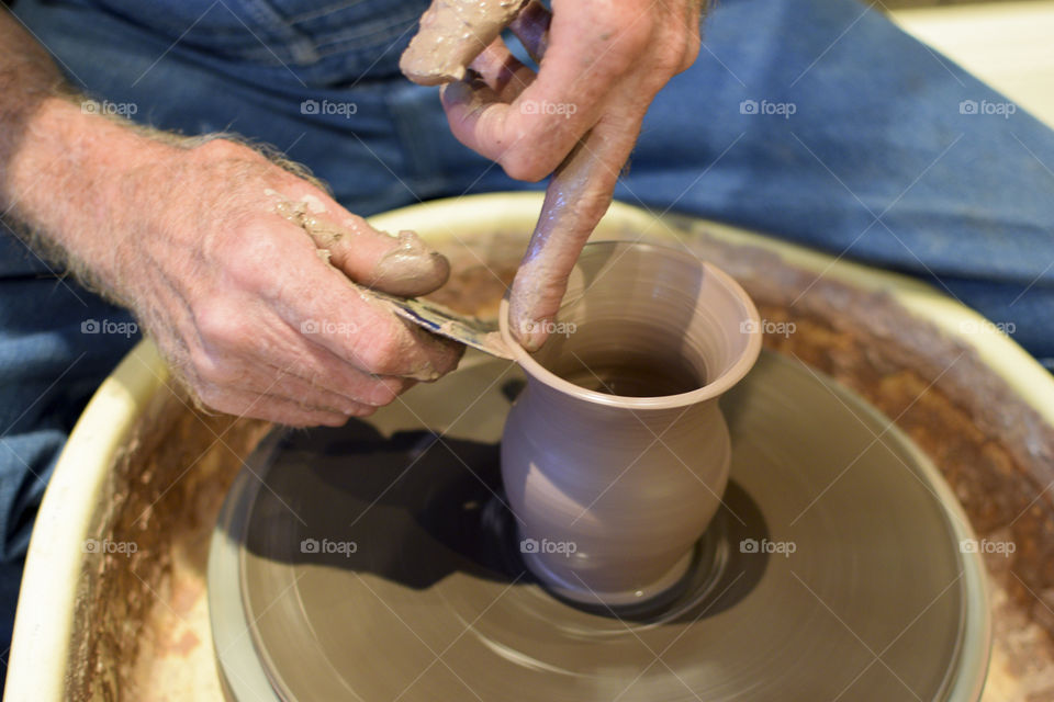 Older Man using a Potter’s wheel to create pottery