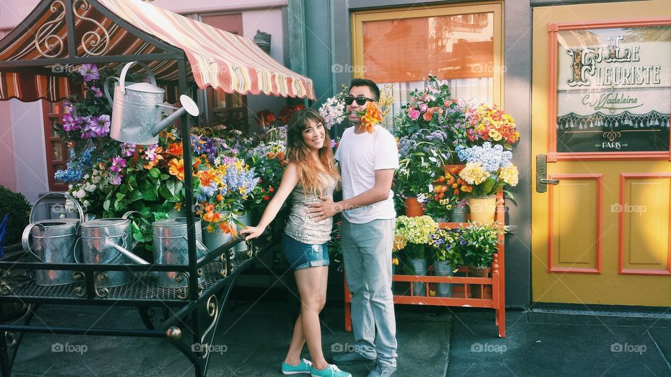 Cute couple surrounded by flowers making a silly pose