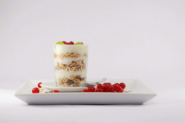 Tasty dessert in plate on white background