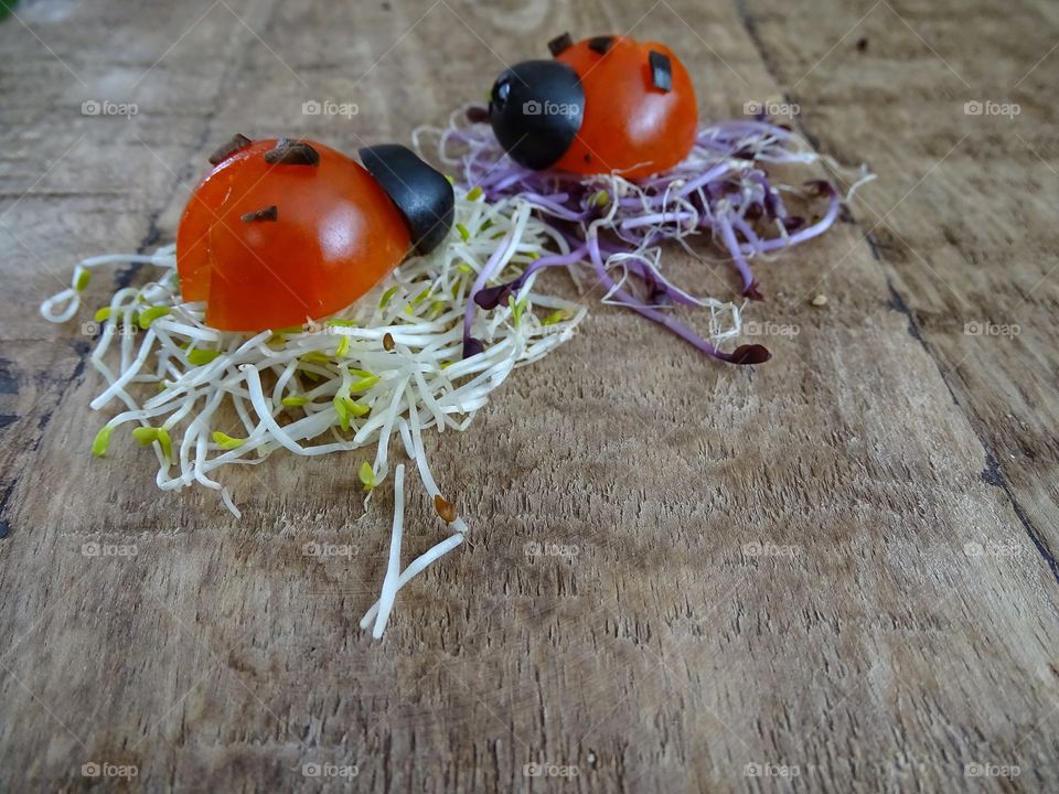 Ladybugs made of tomato and olives