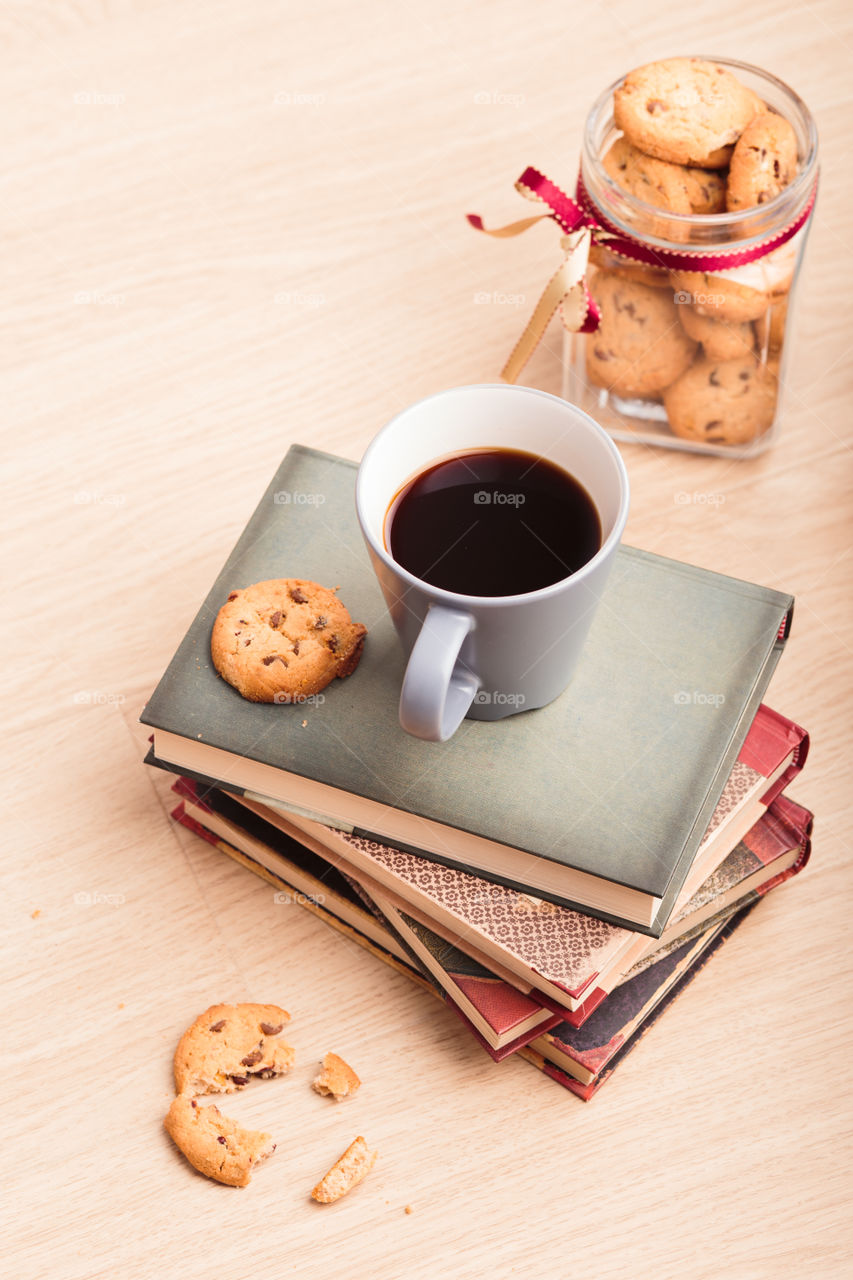 A few books with cup of coffee and cookies on wooden floor. Time for relax. Spending leisure time on reading. Cozy and comfortable. Relaxing 😌