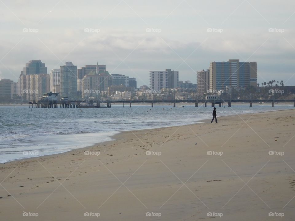 Single person walking on beach 