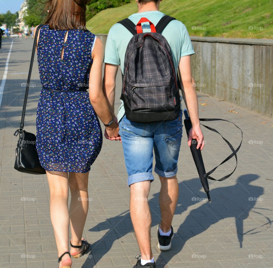 couple walking on a street summer time