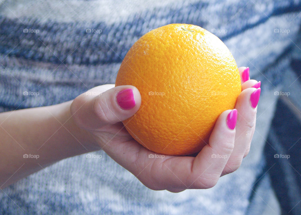 Women holding an orange