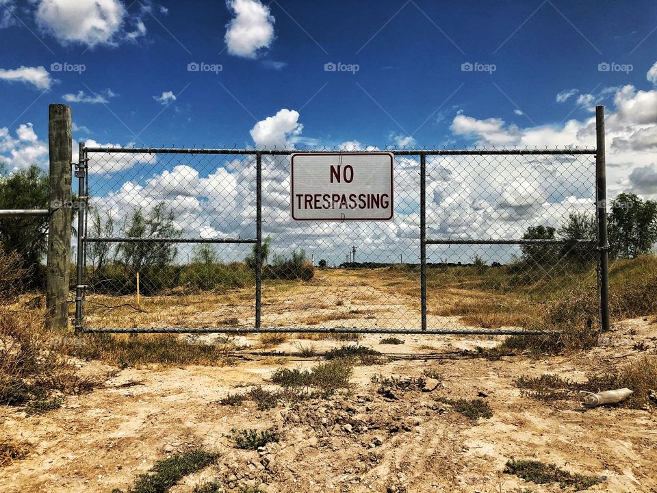 Access gate with no trespassing sign 