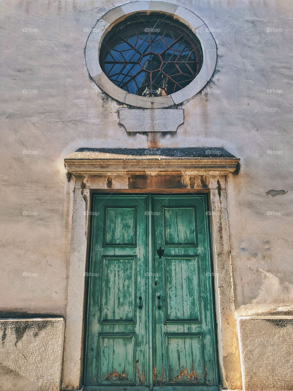 Green door in old streets of Koper