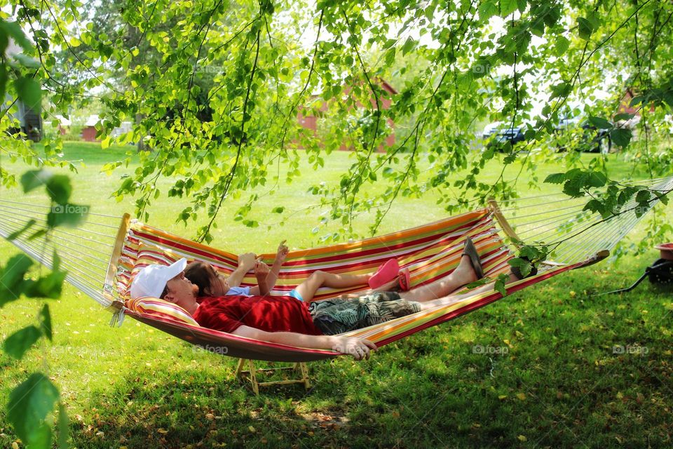 in the hammock under the tree,  hiding from the sun