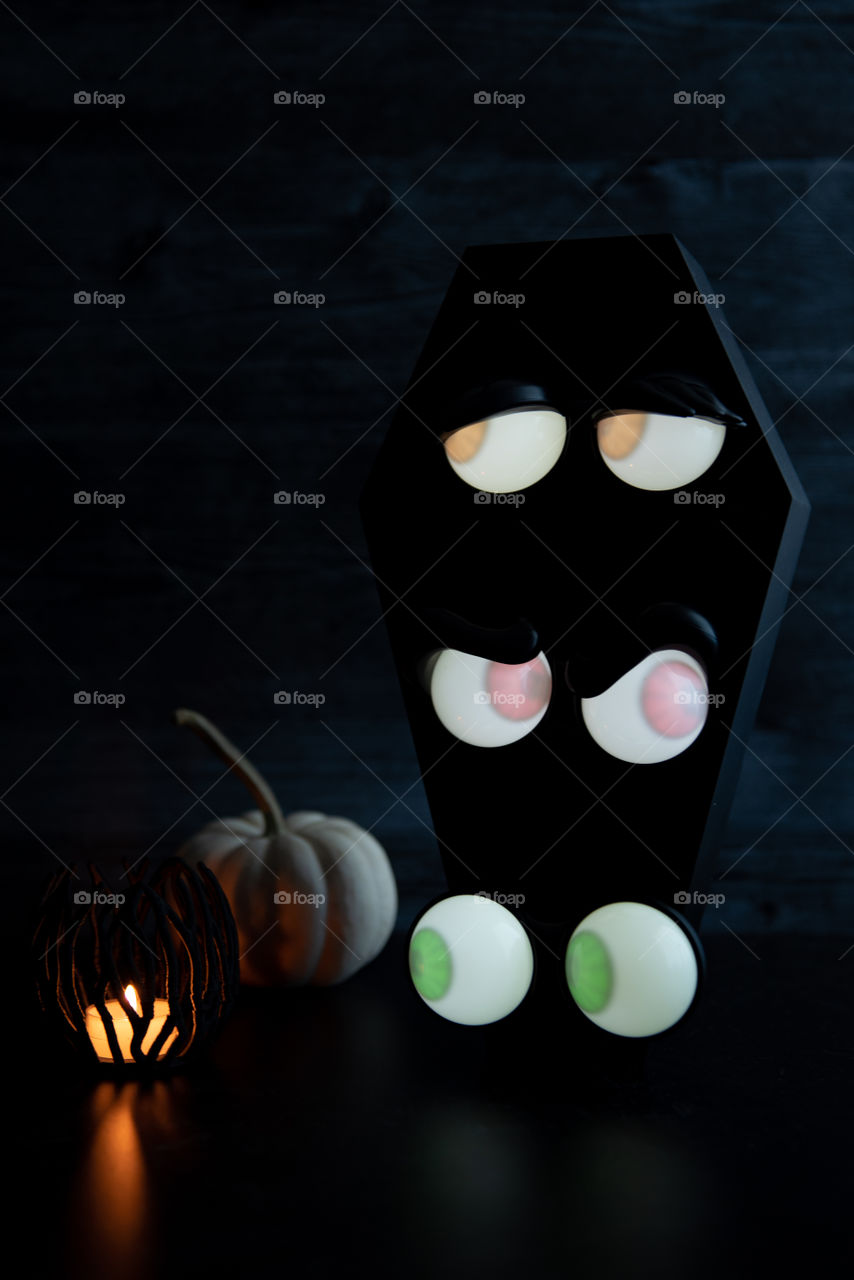 Halloween glowing eyes decoration in a coffin 