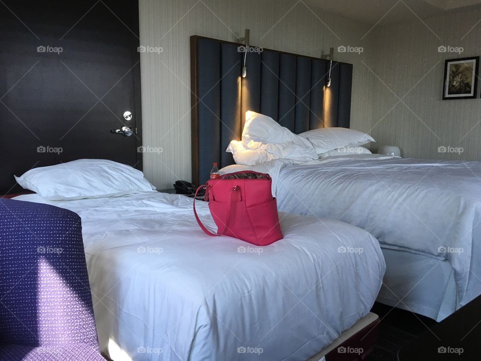 My pink purse on hotel bed.  