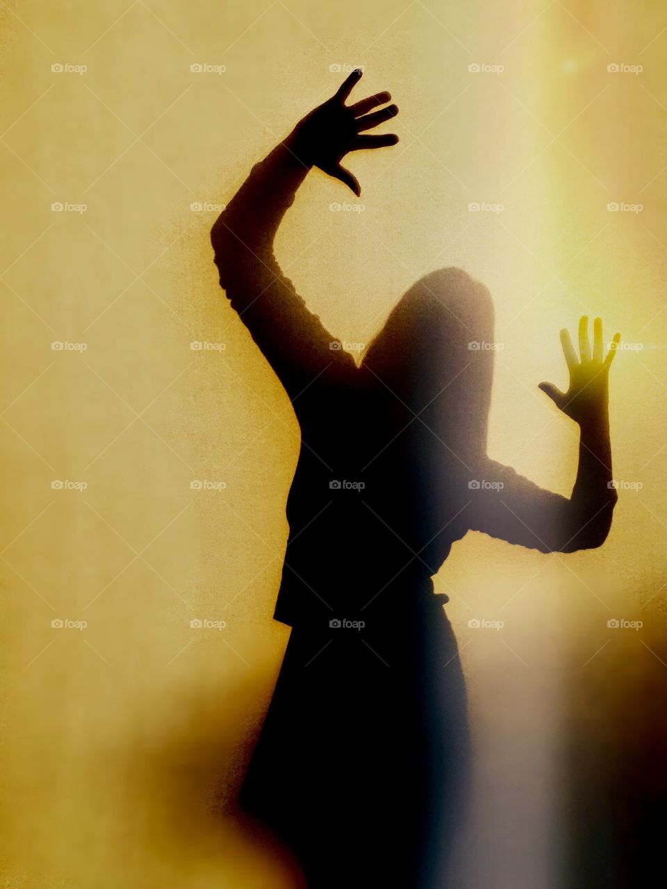 Young woman silhouette against a vibrant yellow background 