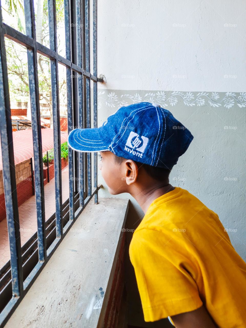 Boy looking through the Window