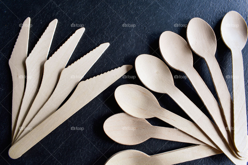 wooden spoons on a black background, wooden spoons and fork, set of kitchen utensils, fork and knife