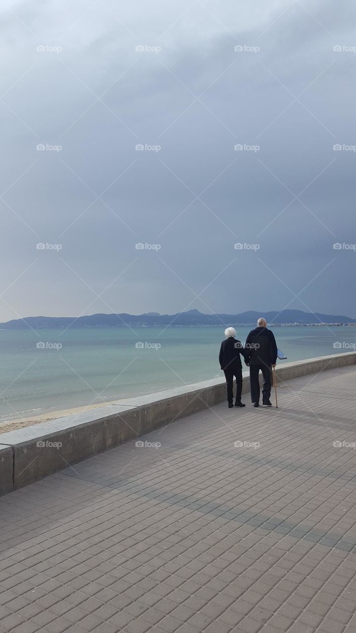 Elderly couple on a walk.