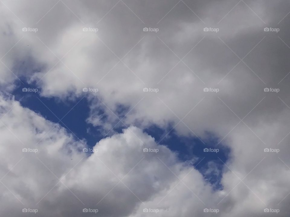 blue sky peaking through clouds