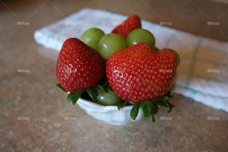 Strawberries with grapes in a bowl 