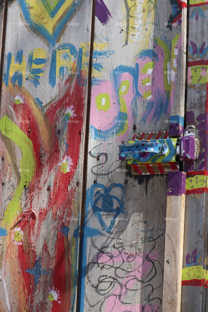 Beatnik hippy type graffiti on old wood door 