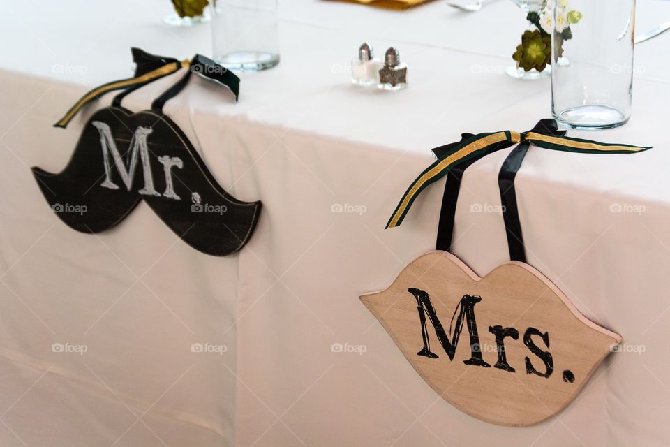 Mr. and Mrs. wedding reception head table with wedding decorations 