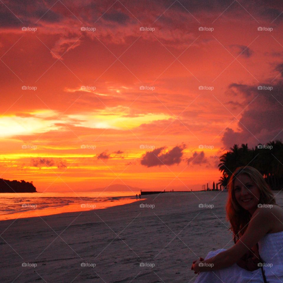 Woman enjoying beautiful sunset at beach