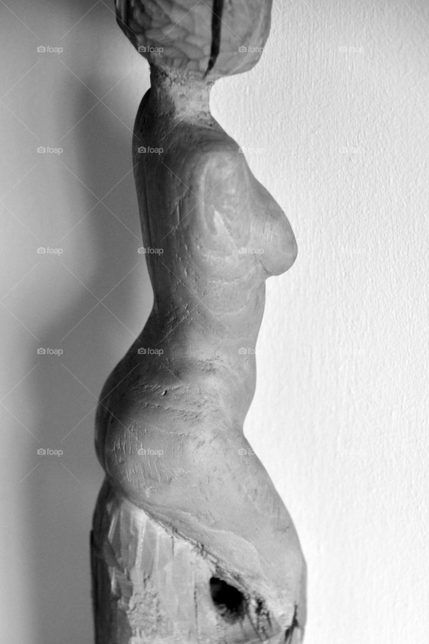 naked body of a woman, wood carving