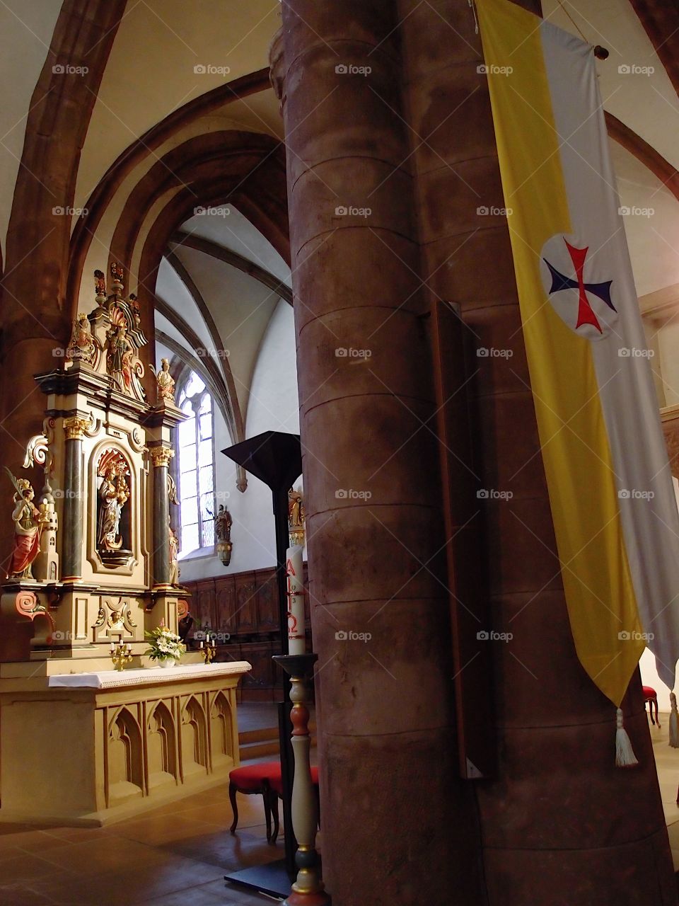 The interior of an old European church with ornate and finely detailed alters and statues. 