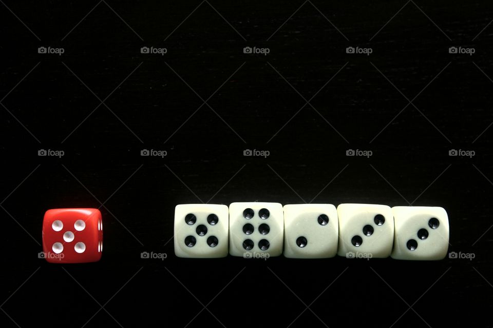 1 red dice among 5 white dice. photo of 1 red dice among 5 white dice