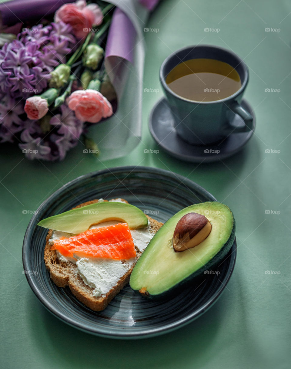 Breakfast with toast with cream cheese, red fish and avocado 